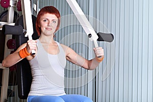 Woman make exercise on training apparatus