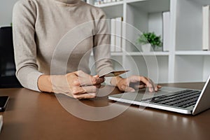 Woman make purchase on Internet, making online payment credit card on laptop