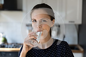 Woman make sip enjoy mineral filtered water staring at camera