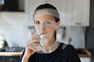 Woman make sip enjoy mineral filtered water staring at camera photo