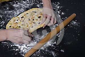 Woman make sweet homemade backery on black table photo