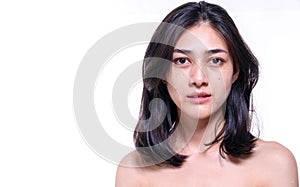 Woman without make up on her face no retouch, fresh face while looking at camera on isolated white background.