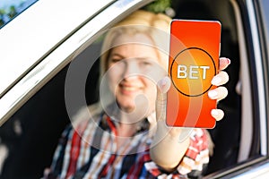 woman makes bets on smartphone