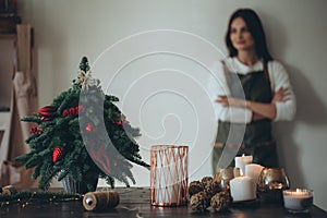 A woman makes a Christmas tree with her own hands.