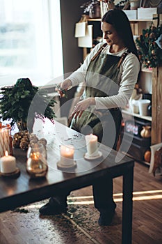 A woman makes a Christmas tree with her own hands.