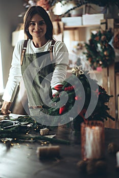 A woman makes a Christmas tree with her own hands.