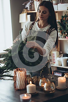 A woman makes a Christmas tree with her own hands.