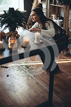 A woman makes a Christmas tree with her own hands.