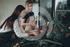 A woman makes a Christmas tree with her own hands.