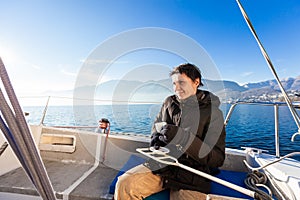 Woman makes a coffee break on the sail boat