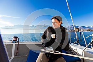 Woman makes a coffee break on the sail boat