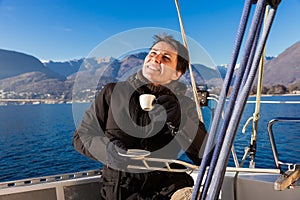 Woman makes a coffee break on the sail boat