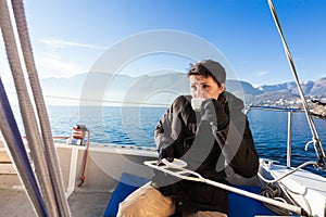 Woman makes a coffee break on the sail boat