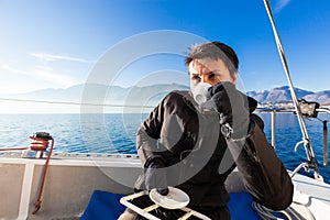 Woman makes a coffee break on the sail boat