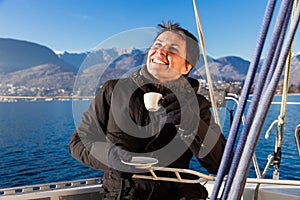 Woman makes a coffee break on the sail boat