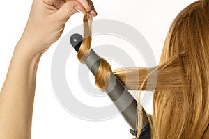 Woman makes a curling hair by herself