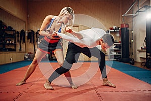 Woman makes elbow kick, self-defense workout