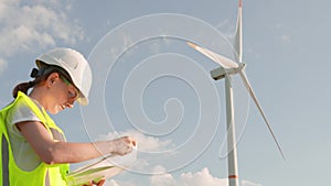 A woman makes an expertise in the field of ecological electricity for a wind turbine of an electric turbine. The concept