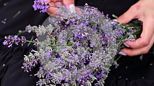 A woman makes a handmade decor from lavender flowers. Close up. Slow motion