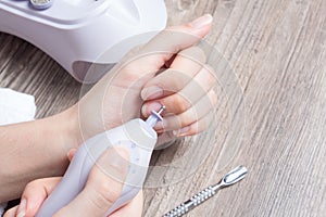 A woman makes her own hardware manicure at home. Close up. Manicure set. Dangerous. Nails. Home care, salon, Spa, beauty, health.