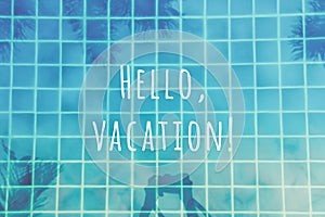 Woman makes pictures of palm trees reflection in the turquoise pool. Multipurpose backdrop with Hello vacation wording