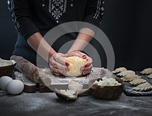 Woman makes varenyky with raspberry