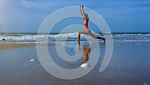 Woman Makes Yoga Warrior Pose on Beach near Foamy Waves