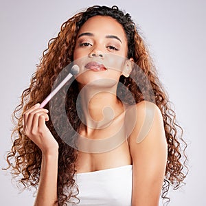 Woman, makeup brush and studio for beauty, cosmetic and skincare on gray background. Cosmetology, portrait and glow skin