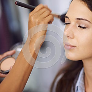 Woman, makeup and cosmetics with brush for facial treatment, beauty or foundation at home. Closeup of female person