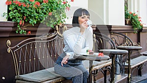 Woman makeup face dreamy brunette eat cake cafe terrace background. Gastronomical enjoyment. Gourmet concept. Girl relax