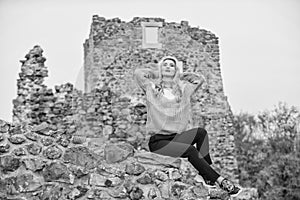 Woman makeup face sit on stony ruins background defocused. Tourism concept. Explore midcentury castle ruins. Fashionable