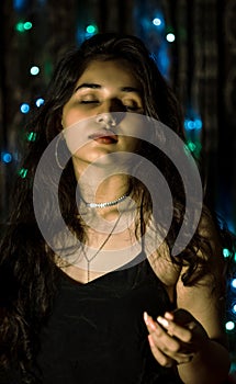 Woman with makeup and a fashionable hairstyle poses