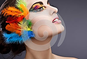 Woman with makeup and feathers