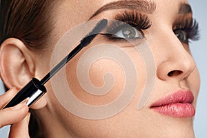 Woman With Makeup, Long Eyelashes Applying Mascara. Doing Makeup