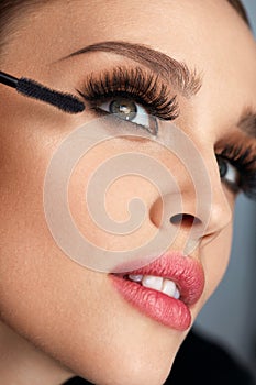 Woman With Makeup, Long Eyelashes Applying Mascara. Doing Makeup