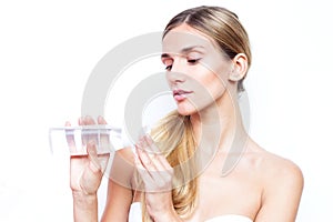 Woman with makeup remover and cotton pad