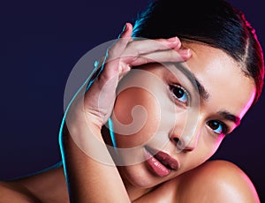 Woman, makeup and skincare in dark studio for beauty, cosmetics or self love with light on face. Model, natural cosmetic