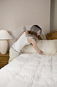 Woman making bed photo