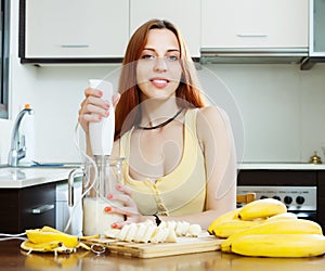 Woman making beverages from bananas and milk