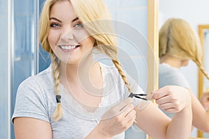 Woman making braid on blonde hair