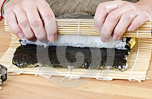 Woman making california roll,