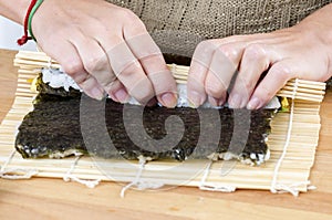 Woman making california roll,