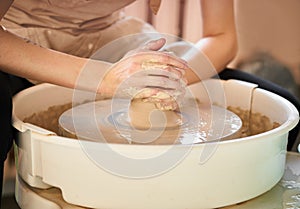 Woman making ceramic pottery on wheel, creation of ceramic ware. Concept of women`s work, craft