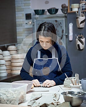 Woman making ceramic pottery on workshop. Concept for woman in freelance, business. Handcraft