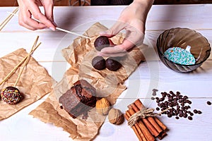 Woman making chocolate popcakes. Cake pops making. Pop cakes.