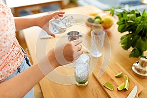 woman making cocktail drinks at home kitchen