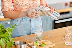 woman making cocktail drinks at home kitchen