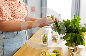 woman making cocktail drinks at home kitchen