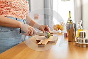 woman making cocktail drinks at home kitchen