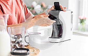 Woman Making Coffee In Coffeemaker
